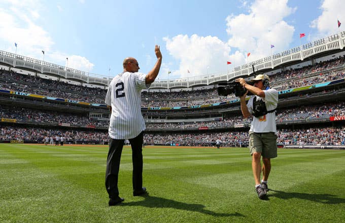 Derek Jeter waves to the crowd as the Yankees introduce the 1996 World Series team.