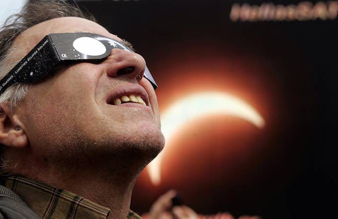A man watches a solar eclipse.