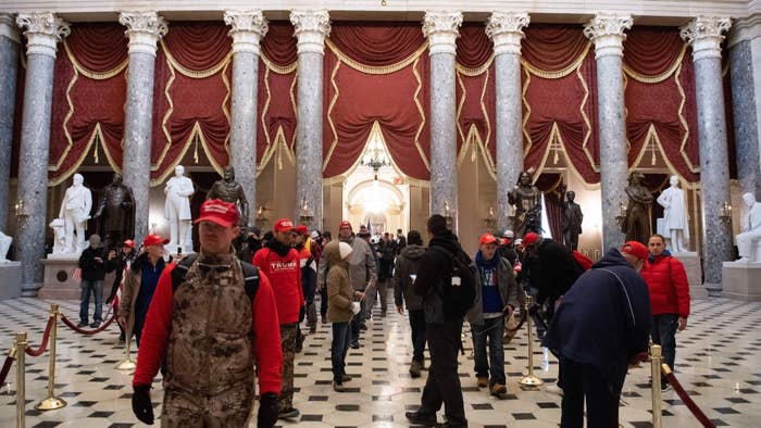 Supporters of US President Donald Trump walk through Statuary Hall