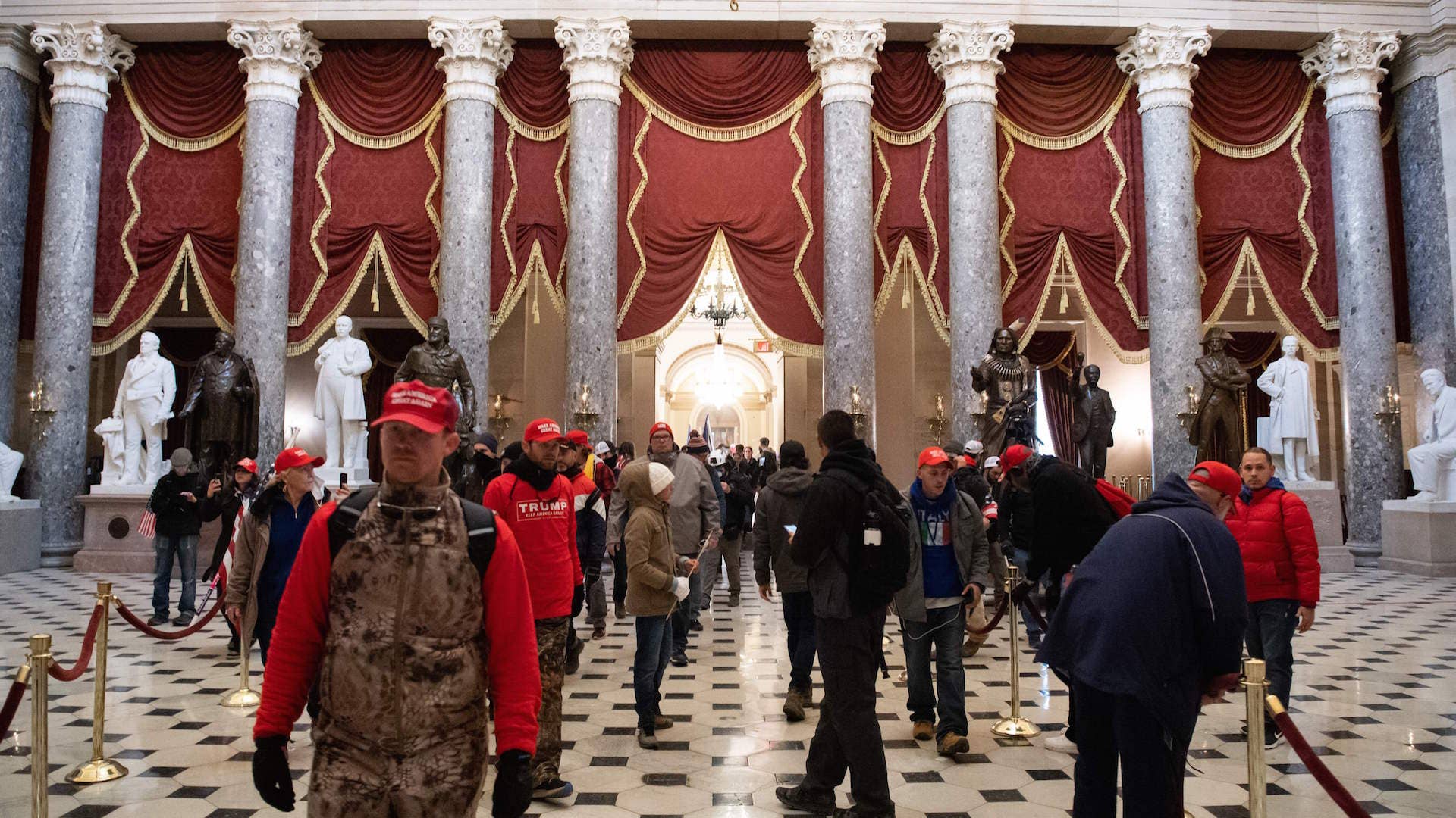 Supporters of US President Donald Trump walk through Statuary Hall