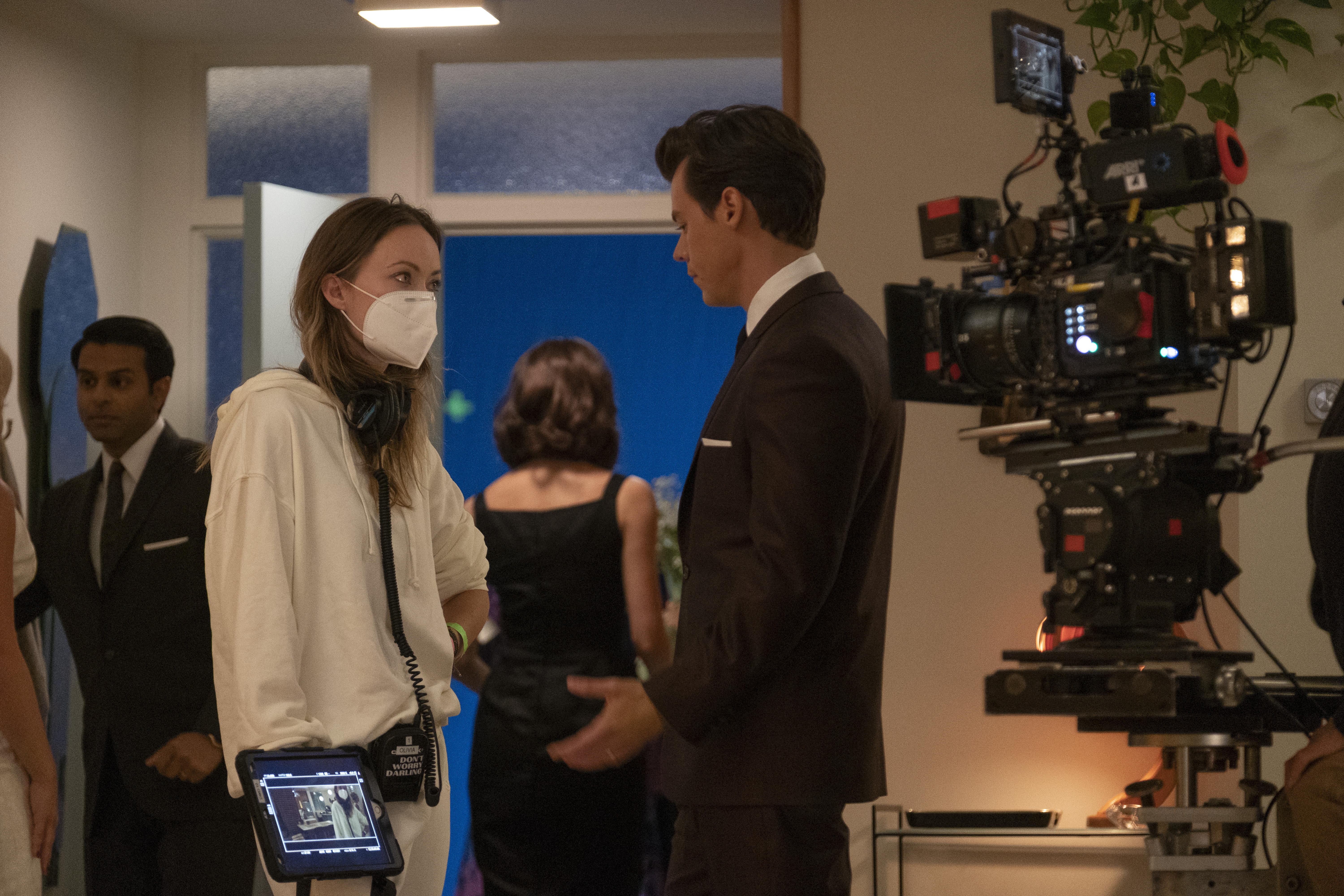 Olivia and Harry are pictured in work mode on the set