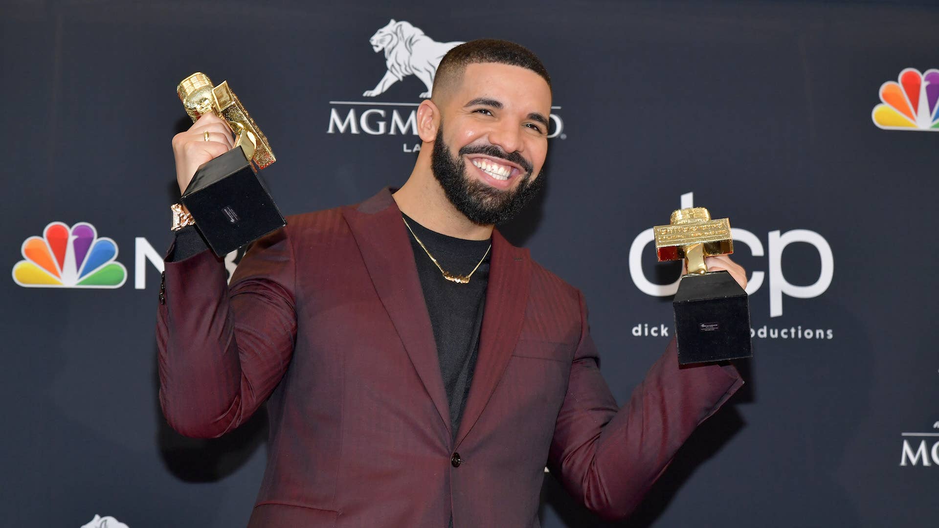 Drake poses with the awards for Top Artist, Top Male Artist, Top Billboard 200 Album