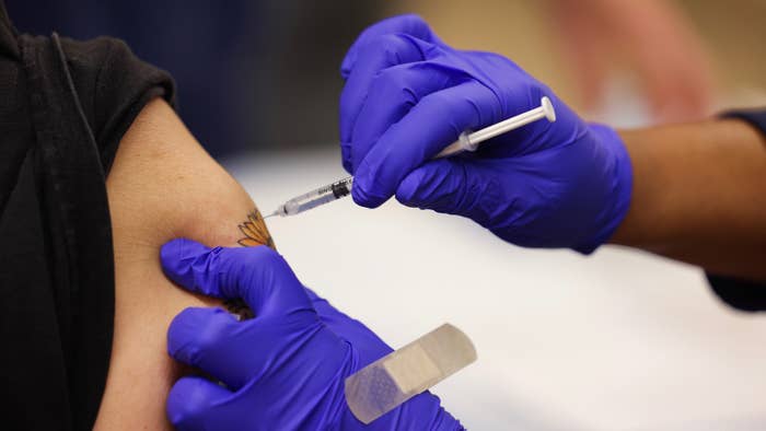 Close-up shot of a Pfizer COVID-19 vaccine booster shot being administered