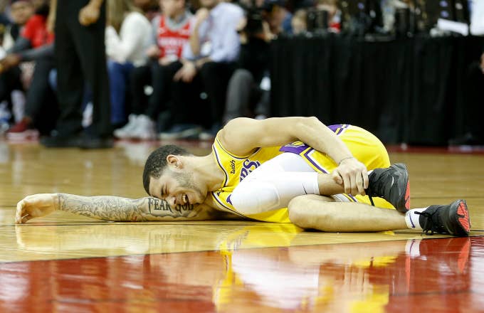 Lonzo Ball #2 of the Los Angeles Lakers lays on the court after an injury
