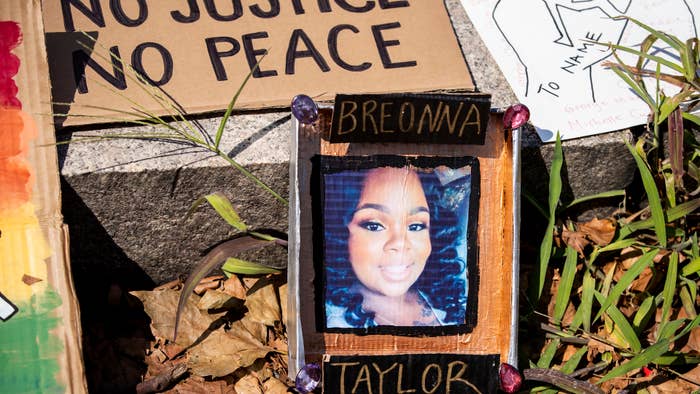 A line of homemade protest signs lay on the steps including one with a picture of Breonna Taylor.