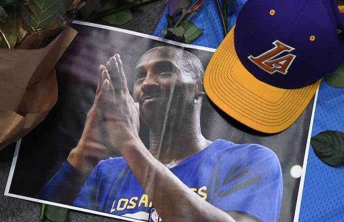 A photo, hat and flowers placed at makeshift memorial as fans mourn the death of Kobe Bryant.