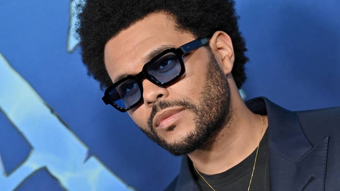 The Weeknd is seen on the blue carpet