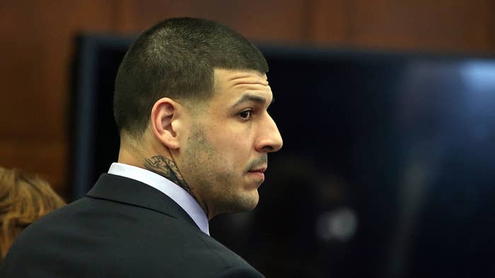 Aaron Hernandez stands at the defense table