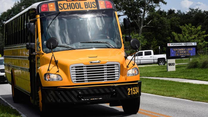 A school bus drives past Pershing School in Orlando. Students in all Orange County schools