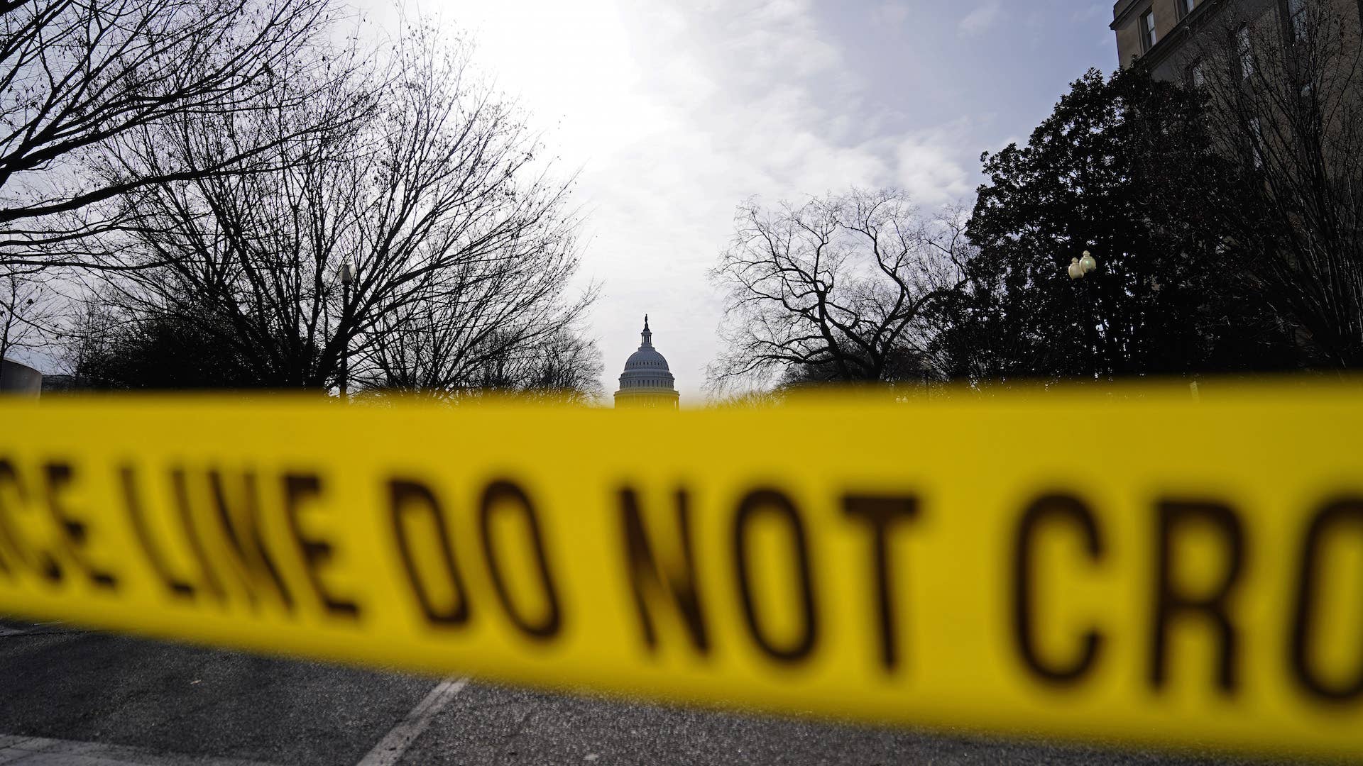 The U.S. Capitol is seen behind yellow police tape