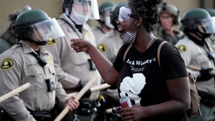 A demonstrator shouts at San Diego Sheriff Department deputies during a Black Lives Matter protest.