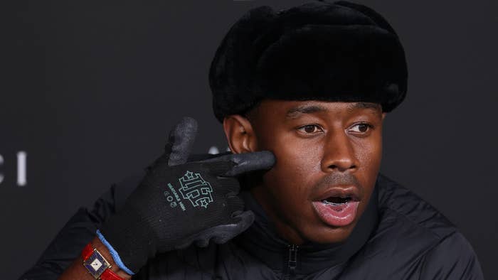 Tyler, the Creator points at his face on the red carpet