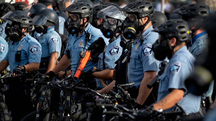 Minneapolis Police officers lined up as demonstrators protested the killing of George Floyd