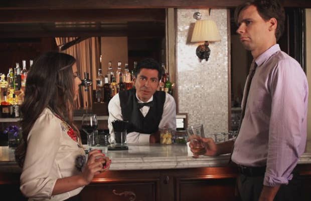 A Woman, Bartender, and Man at a bar