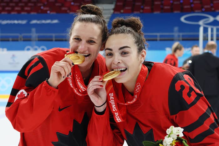Jill Saulnier #11 and Sarah Nurse #20 of Team Canada pose with their gold medals after the Women&#x27;s Ice Hockey Gold Medal match