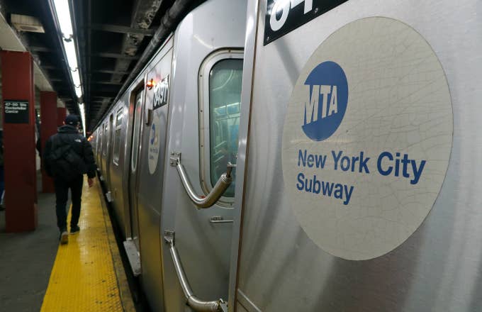 A subway train pulls into a station under Rockefeller Center