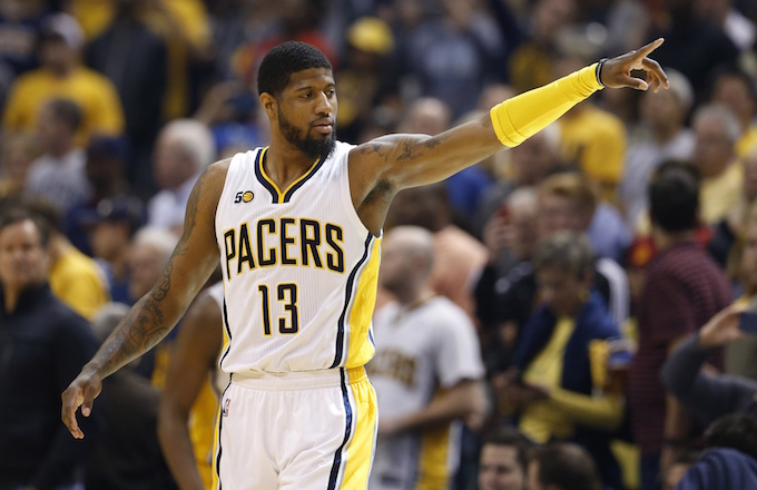 Paul George points during game.
