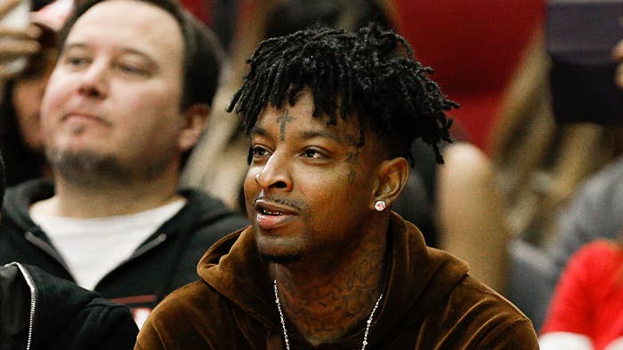 21 Savage watches from court side as the Denver Nuggets played the Houston Rockets