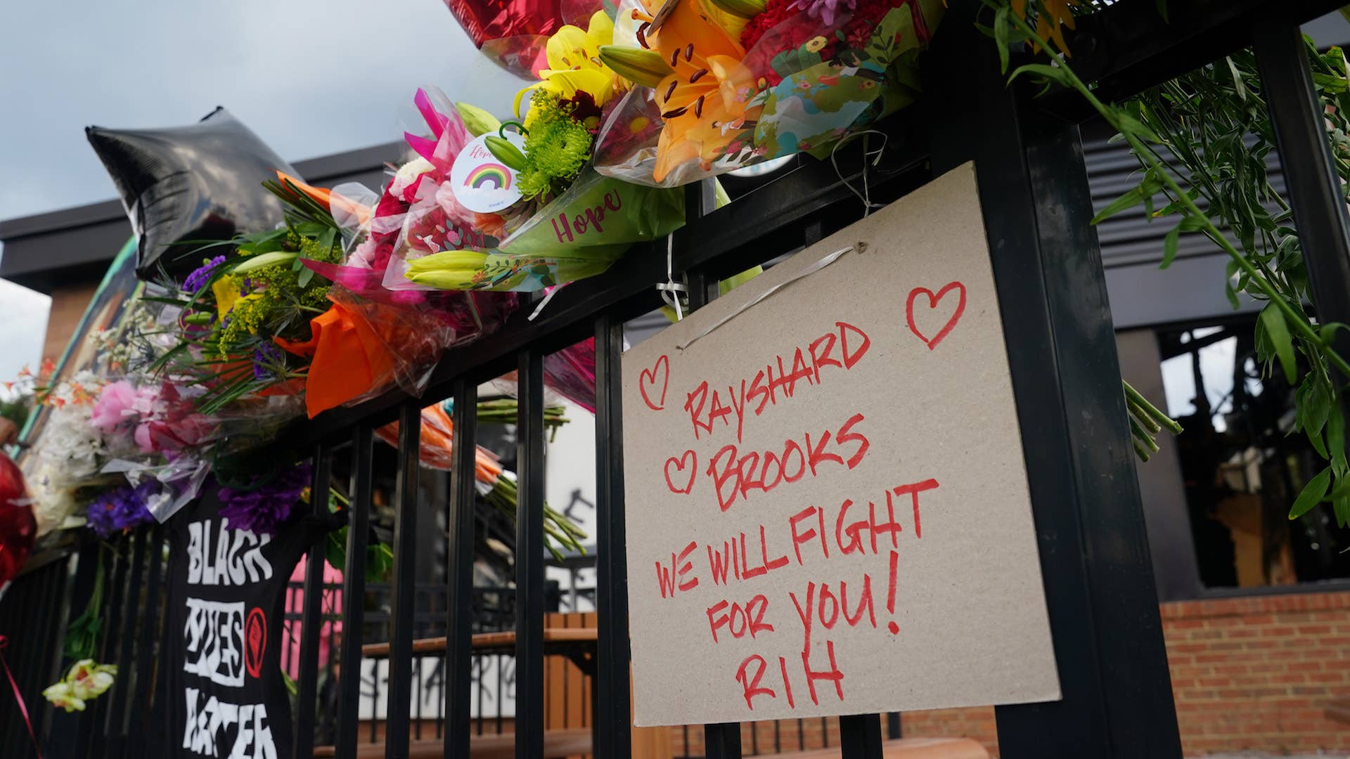 Message to Rayshard Brook is seen on a patio railing outside a burned Wendys