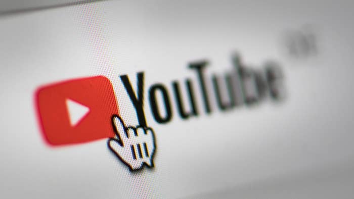 In this photo illustration the mouse cursor is pictured on the YouTube logo.