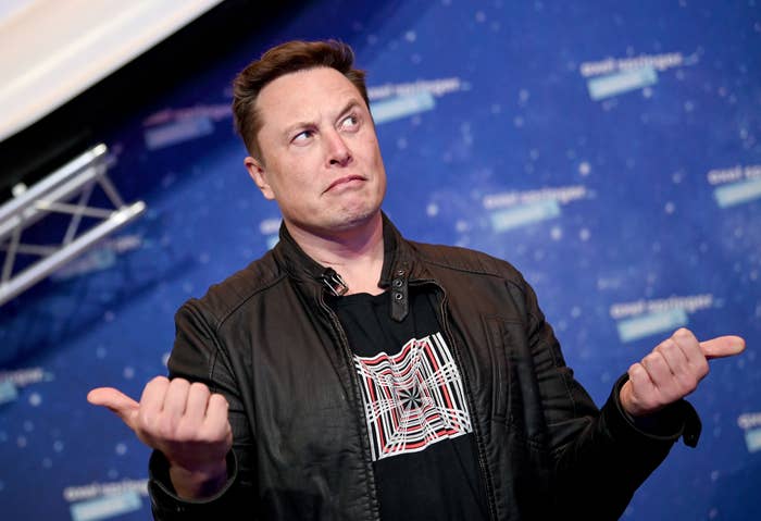 Elon Musk gestures as he arrives on the red carpet for the Axel Springer Awards ceremony