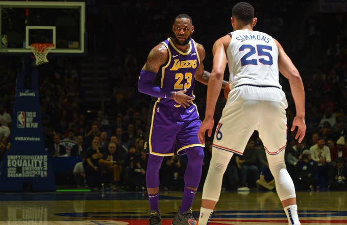 LeBron James #23 of the Los Angeles Lakers handles the ball against Ben Simmons