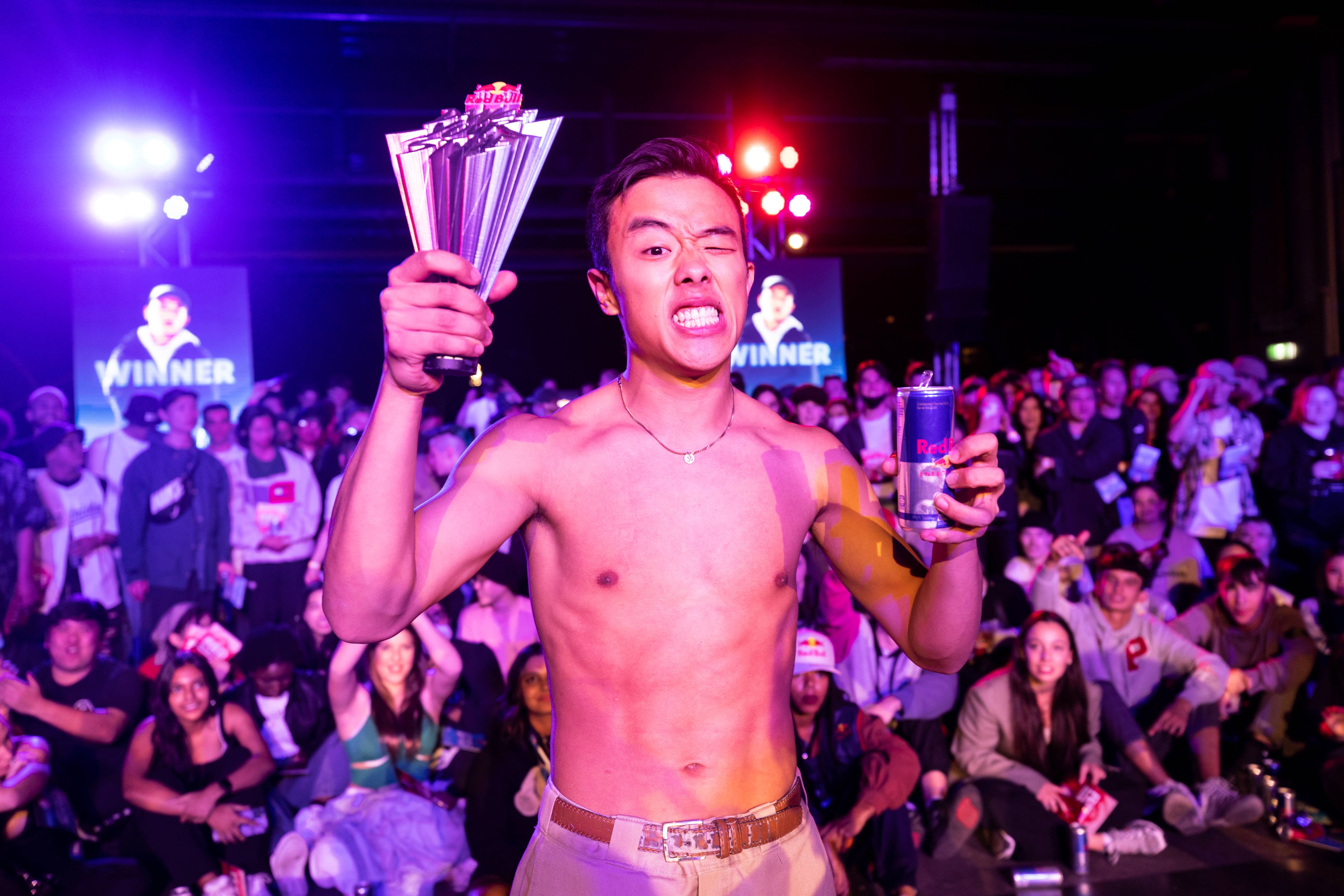 Koh Yamada, the winner of Red Bull's Dance Your Style National Final, stands in front of a crowd holding a trophy