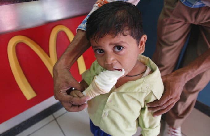 A Child eating ice cream at a McDonalds outlet, India.