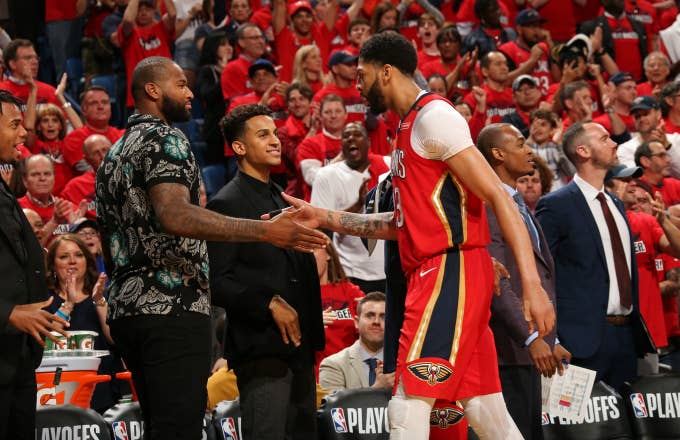 Anthony Davis #23 of the New Orleans Pelicans high fives DeMarcus Cousins #0
