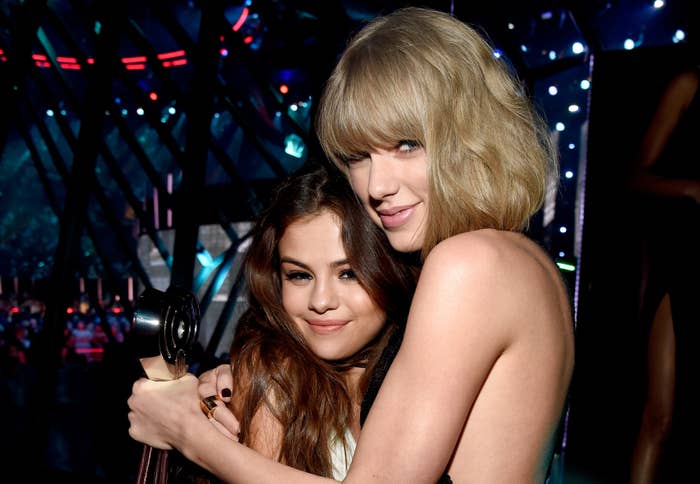 Taylor Swift and Selena Gomez hugging at an event