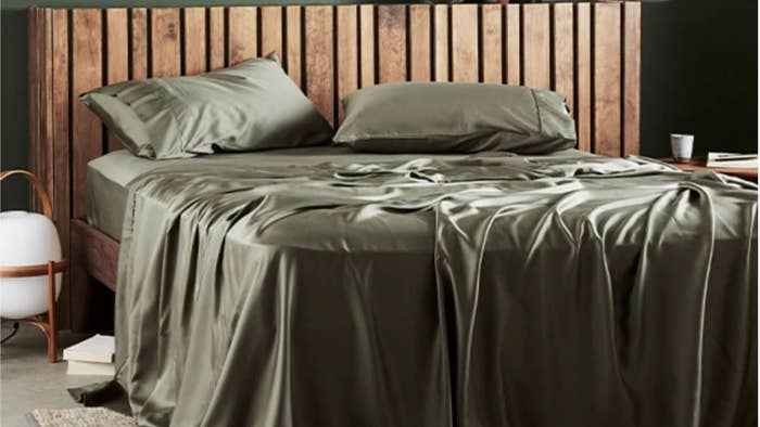 Sleek, minimalist bedroom with wooden slat headboard and luxurious silky bedding