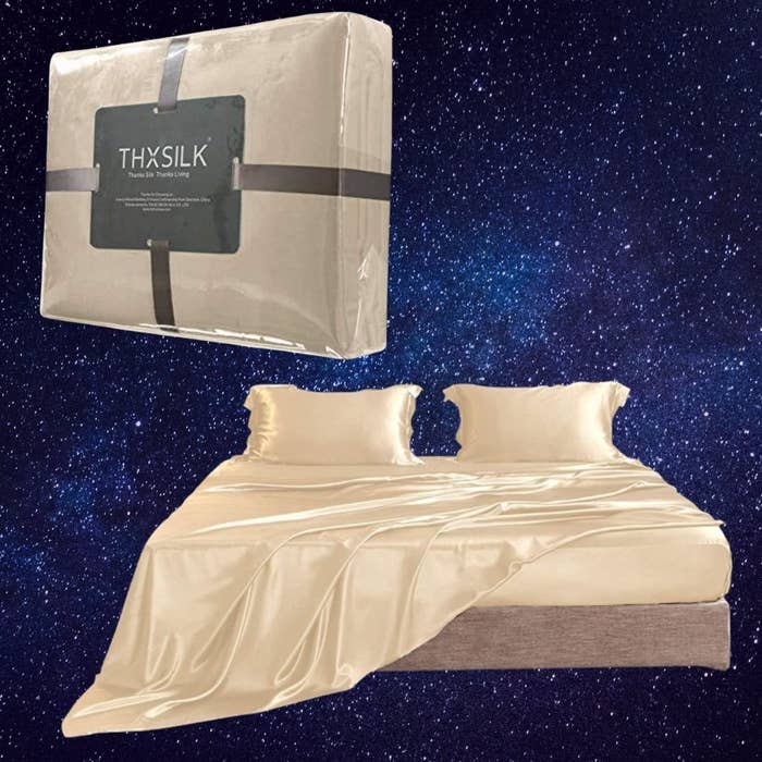 Silk bedding set on a bed with matching pillowcases, showcased against a starry background. Packaging displayed above