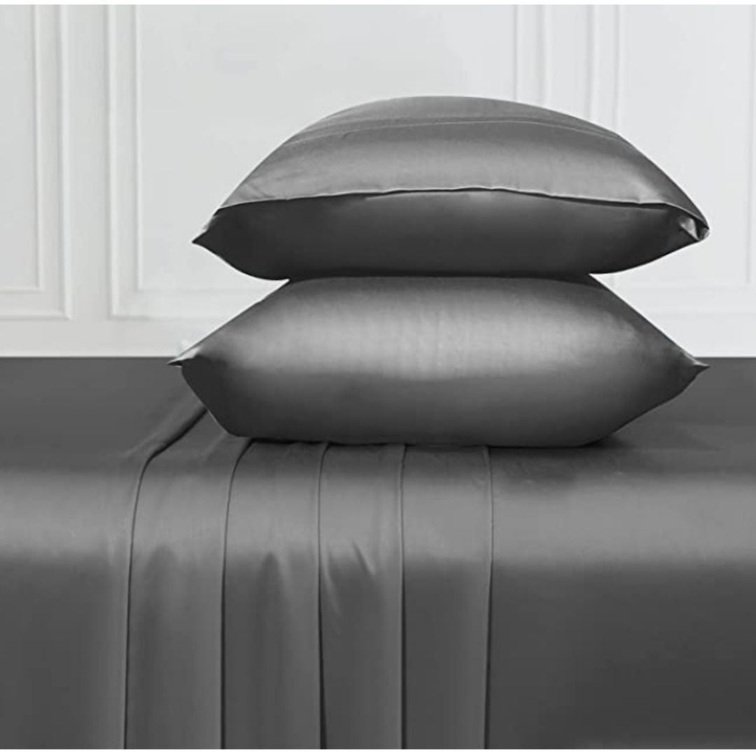 Two stacked satin pillowcases on a satin bedspread, showcasing a smooth and luxurious fabric texture. Ideal for a shopping article on bedding