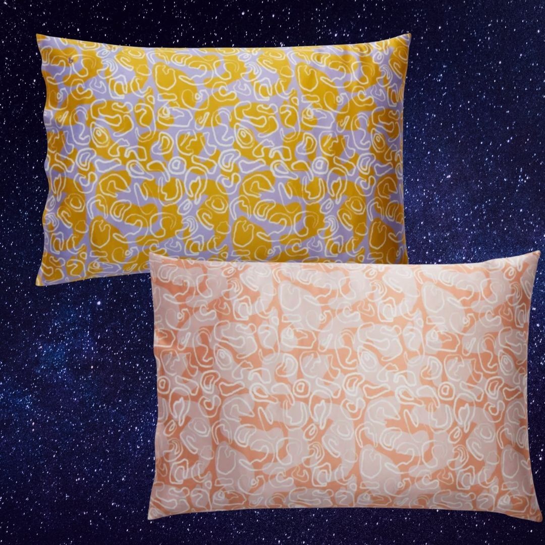 Two decorative pillows with abstract line patterns against a starry background. Suitable for home decor shopping