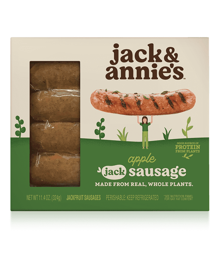 Packaging of jack &amp;amp; annie's apple sausage, made from real, whole plants. The package shows sausages through a transparent section and a character holding a large sausage