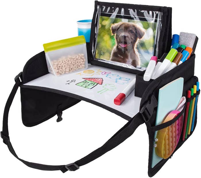 Lap desk with storage pockets, shown with a child’s drawing mat, markers, eraser, and a framed photo of a puppy