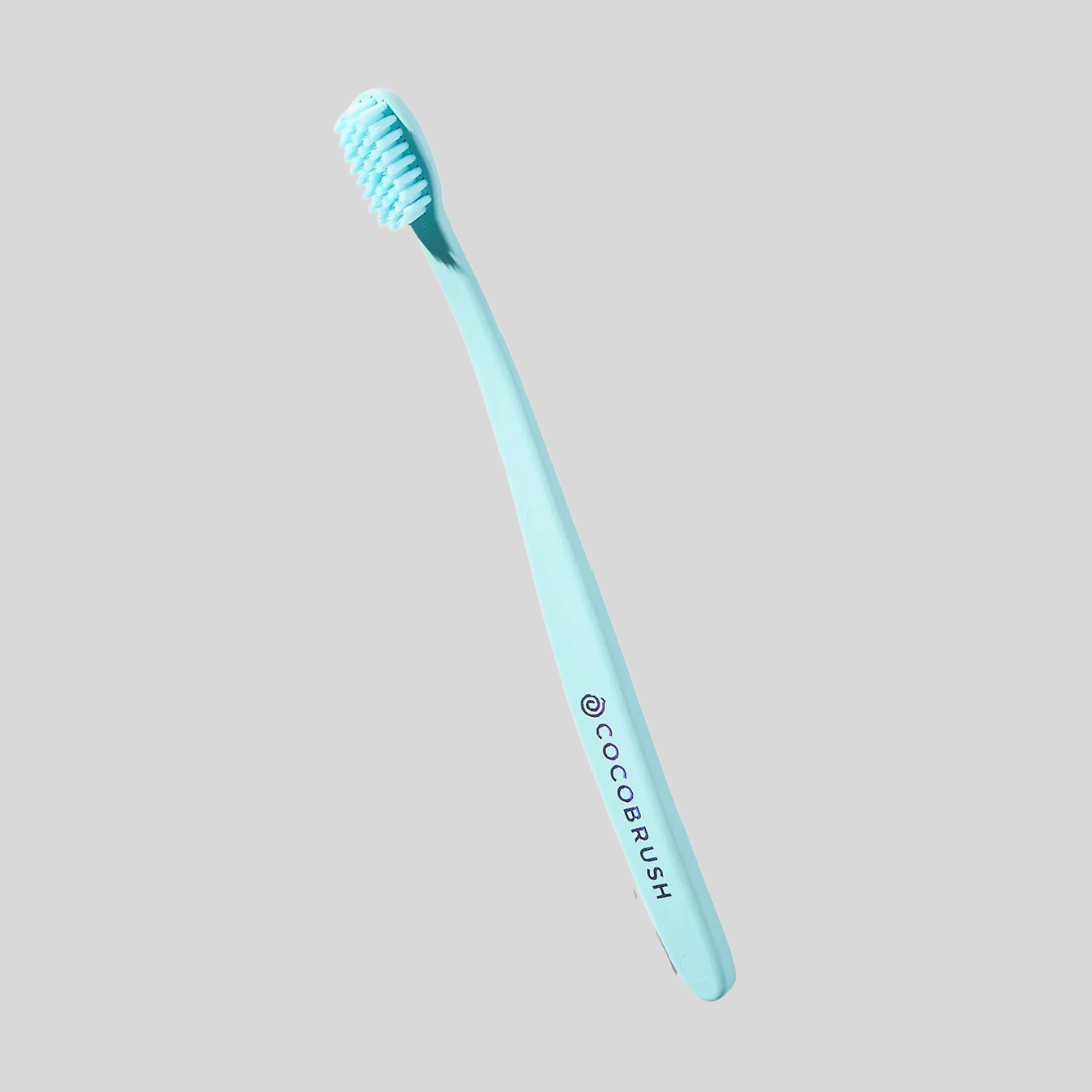 Light bluish toothbrush with "Cocobrush" substance connected the handle. Suitable for nonfiction connected shopping