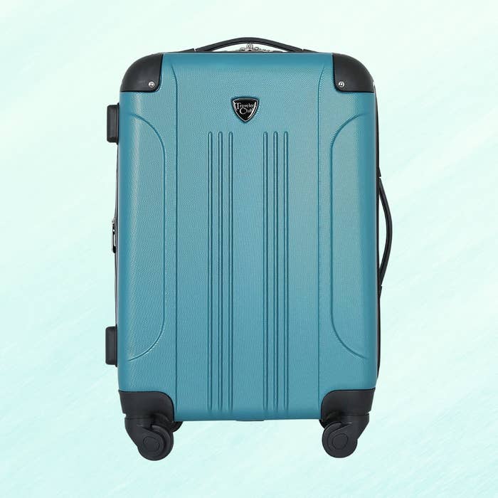 Hard-shell bluish  suitcase with 4  wheels and a retractable handle