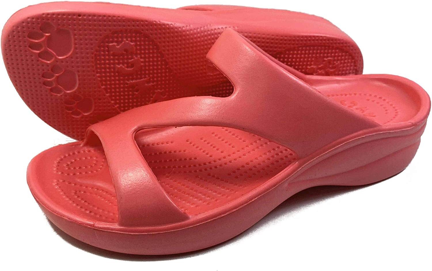 A pair of red sandals with a textured insole and patterned outsole, no persons present