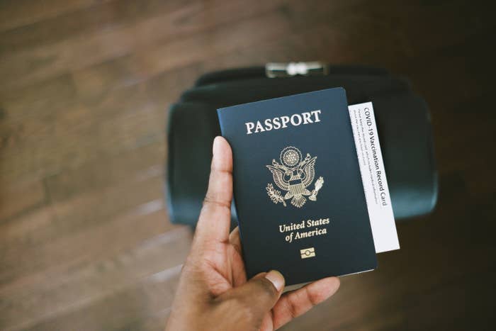 A hand holding a passport
