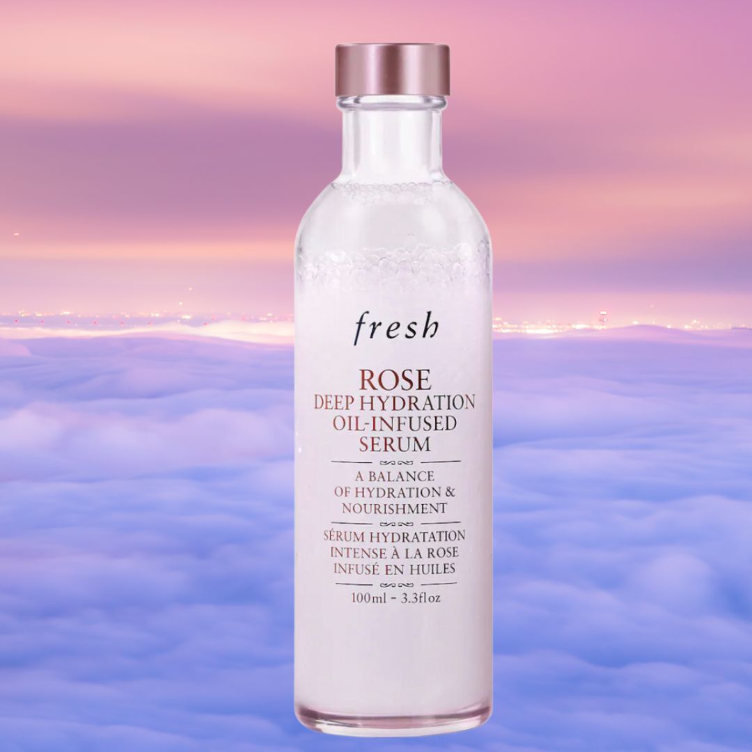 A bottle of Fresh Rose Deep Hydration Oil-Infused Serum, 100ml, displayed against a backdrop of clouds. The product promises hydration and nourishment