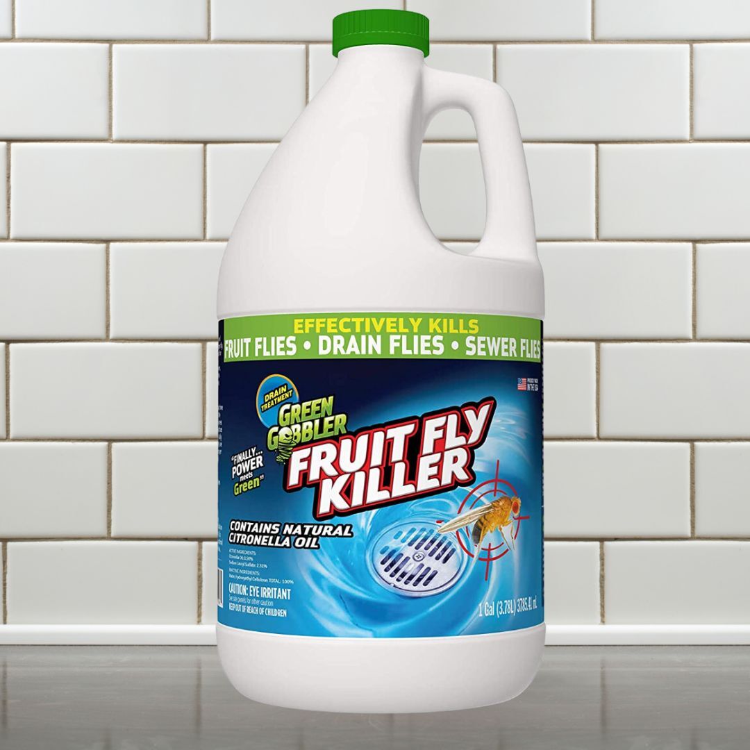 Green Gobbler Fruit Fly Killer jug displayed connected  a room  antagonistic  with tile backdrop. Labels item   effectiveness against fruit, drain, and sewer flies