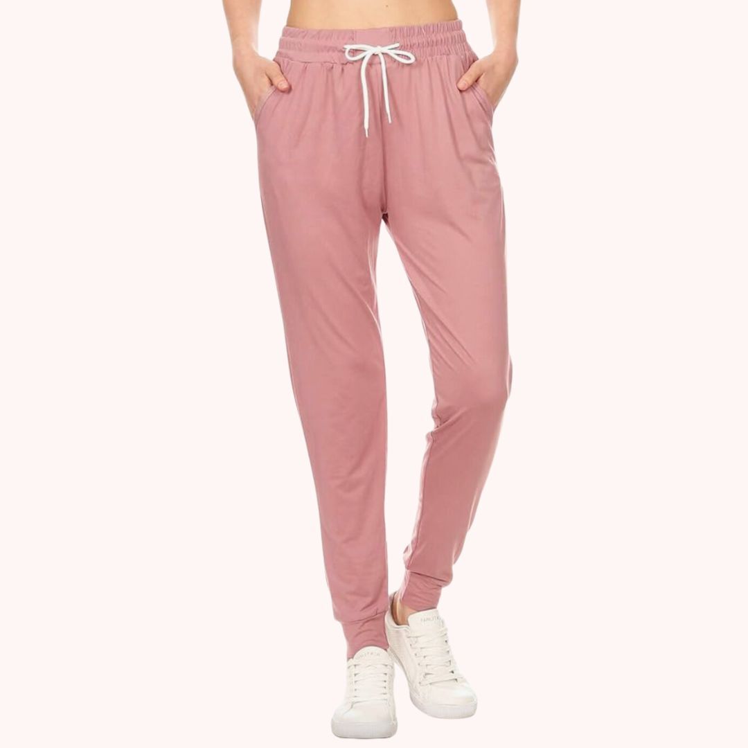 Person wearing pink drawstring joggers and white sneakers