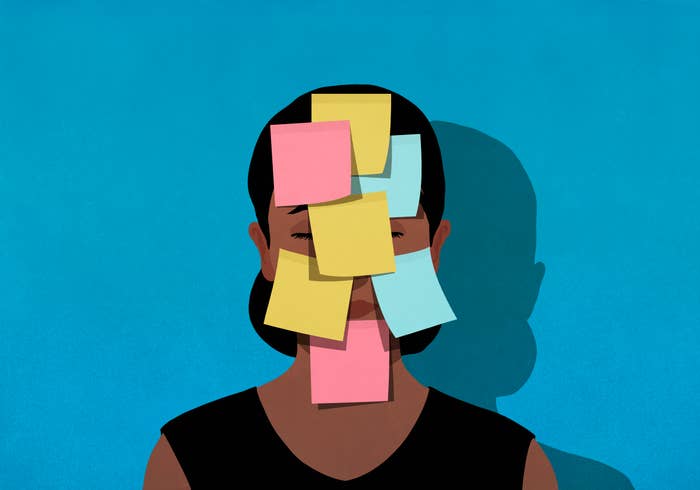 Person with sticky notes on face to symbolize organization and mental load