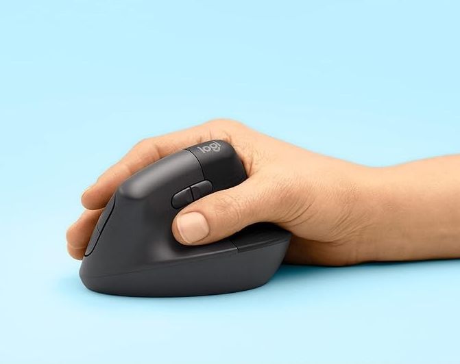 Person's hand resting on an ergonomic wireless mouse against a plain background