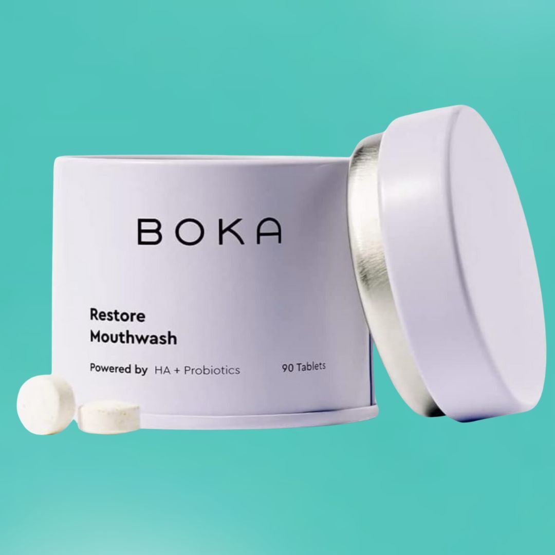 Boka Restore Mouthwash tablets with HA and probiotics, shown successful a cylindrical instrumentality with a lid, against a plain background