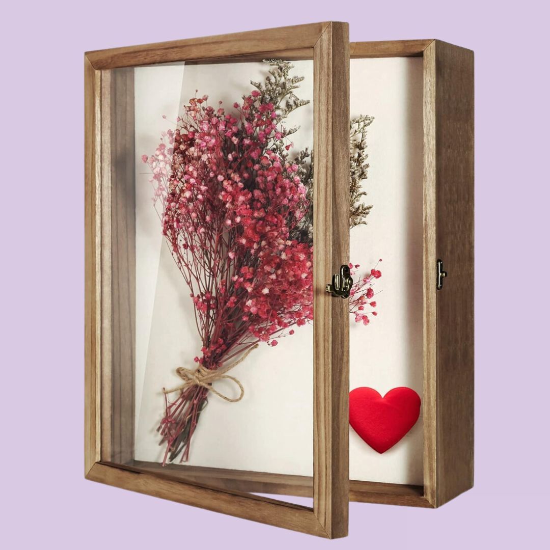 the shadow box with dried lowers in it