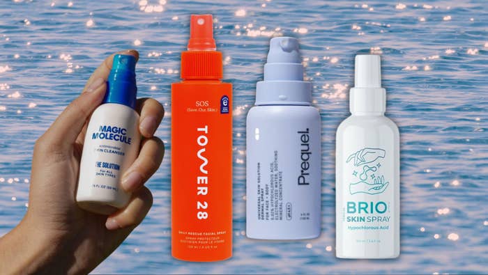 Four skincare products are held aloft against a background of sparkling water