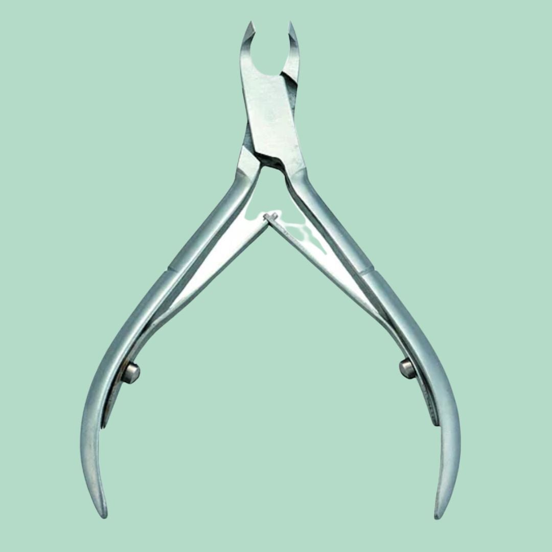 Metal nail cuticle nipper instrumentality connected a plain background