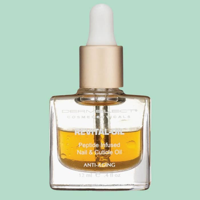 Clear solid  vessel  of Dermelect Revital-Oil, a peptide-infused nail and cuticle lipid  for anti-aging, with a dropper top